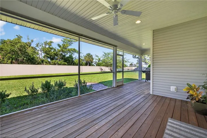 Unfurnished sunroom with ceiling fan