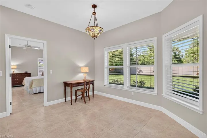 Dining area with light tile patterned floors and ceiling fan