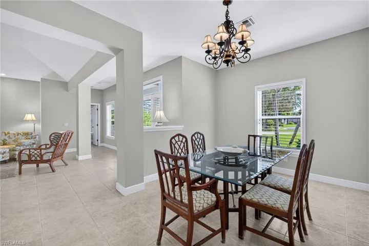 Dining space featuring a chandelier and light tile patterned flooring