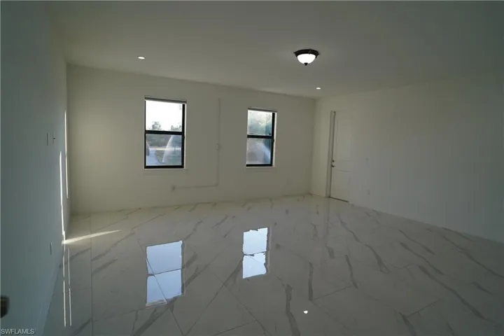 Unfurnished room featuring recessed lighting and baseboards