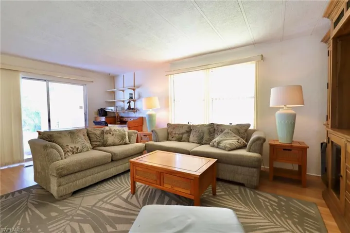 Living room with hardwood / wood-style flooring and a textured ceiling