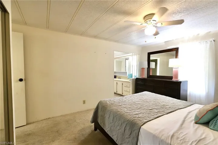 Carpeted bedroom with ceiling fan