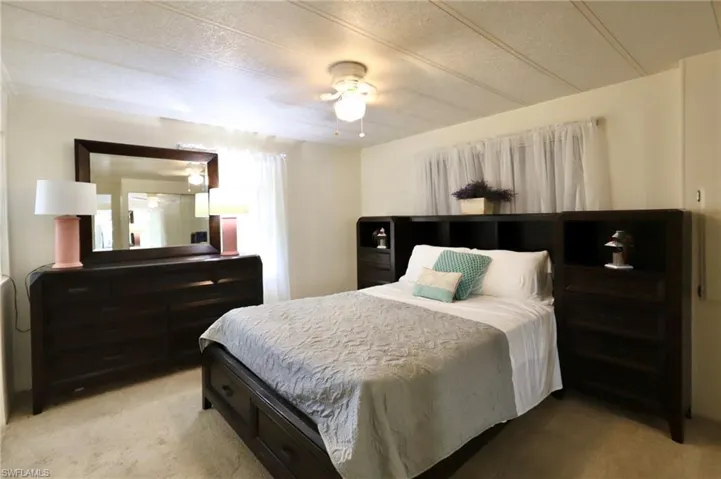 Carpeted bedroom with ceiling fan