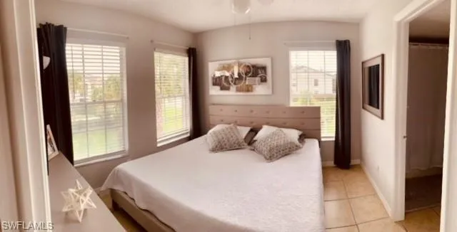 Bedroom featuring light tile patterned floors and a ceiling fan