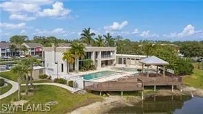 Rear view of property with a community pool