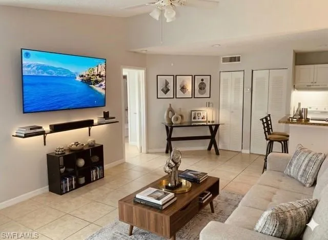 Living room featuring ceiling fan and light tile patterned flooring