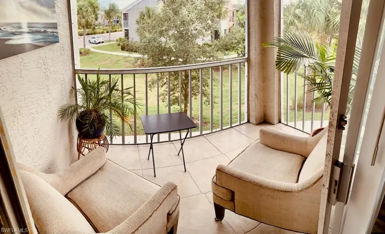Balcony featuring a sunroom