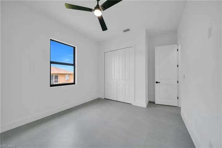 Unfurnished bedroom featuring a closet and a ceiling fan