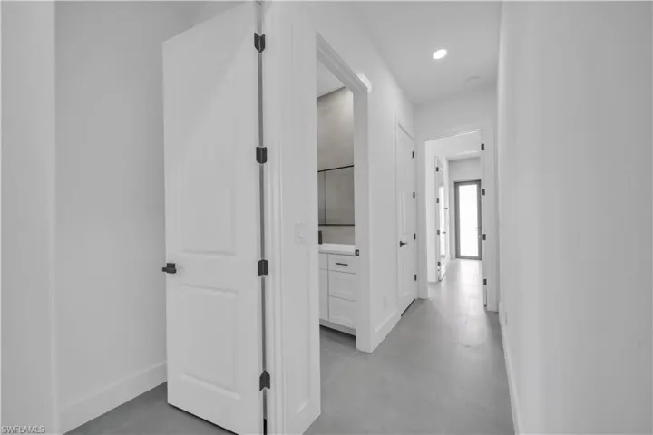Hallway with baseboards and recessed lighting