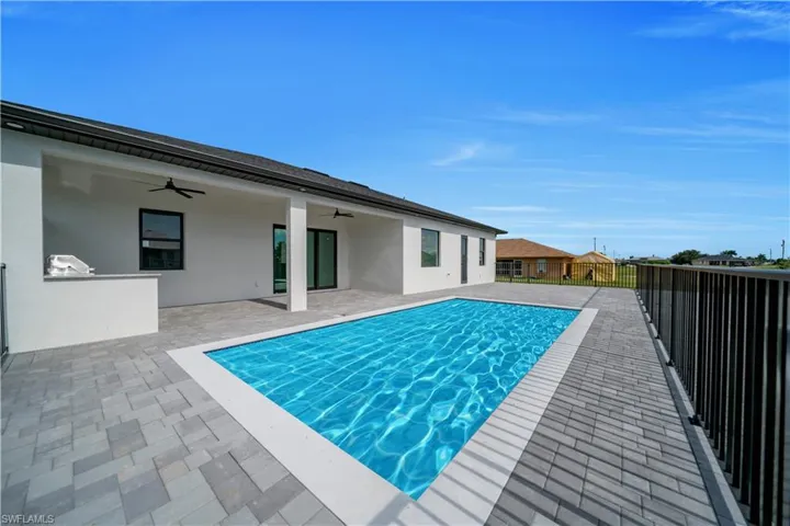 View of swimming pool featuring a ceiling fan and a patio area