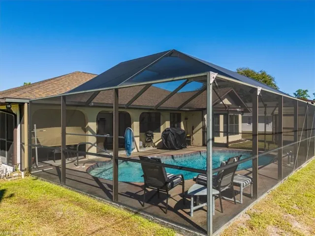 Enclosed pool cage w/new screens, pool heater, and newly resurfaced pool!