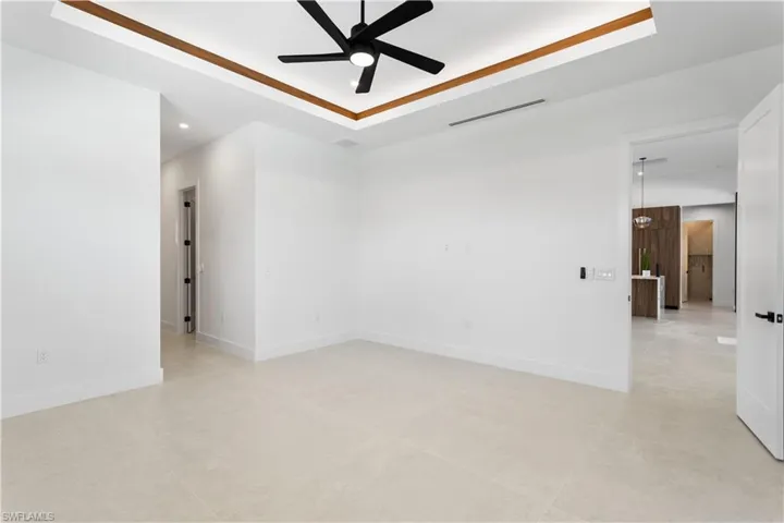 Discover the ultimate retreat in this spacious master bedroom, featuring abundant natural light, a luxurious ensuite bath, and ample room for a cozy sitting area, perfect for unwinding in style!