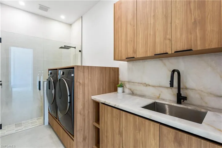 LAUNDRY ROOM includes CLEANING STATION for YOU or FURRY BABIES, WASHER & DRYER, LAUNDRY TUB w/ FULL BACKSPLASH & CUSTOM STORAGE CABINETS