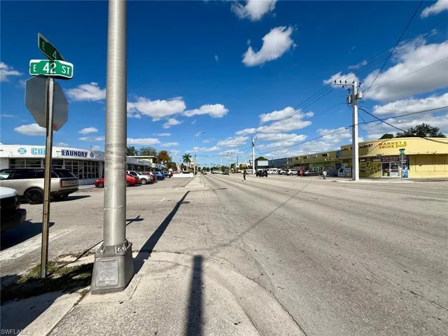 View of asphalt street with traffic signs