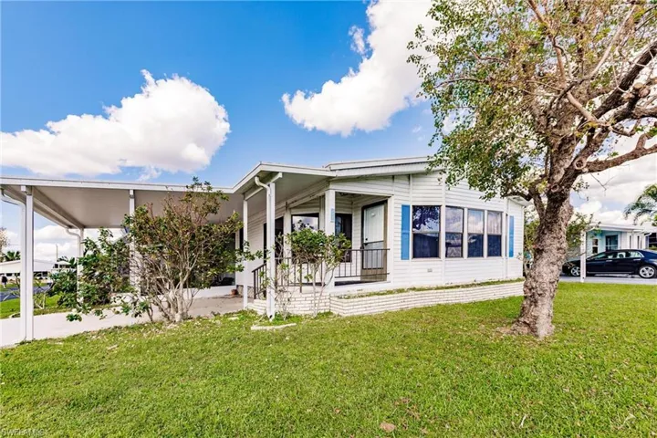 Manufactured / mobile home with a porch and a front lawn