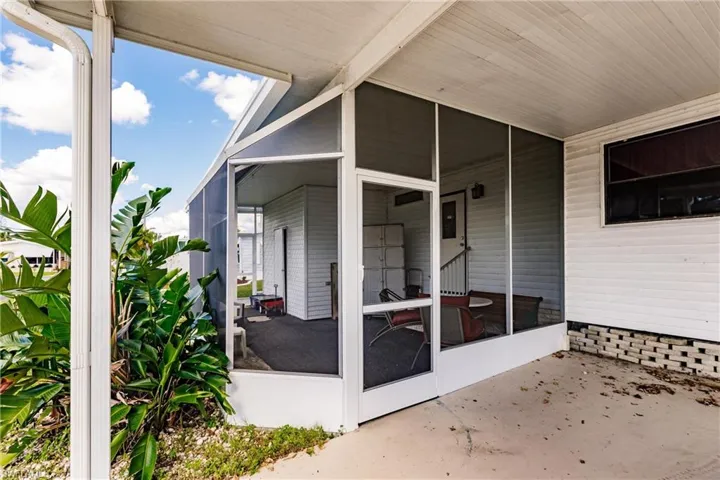 View of patio with a sunroom
