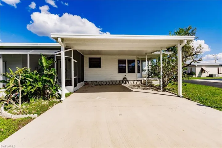 View of patio / terrace with a sunroom and a carport