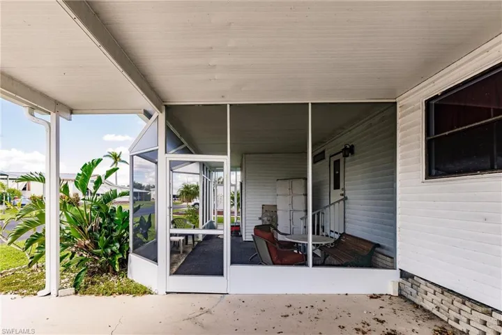 View of patio with a sunroom