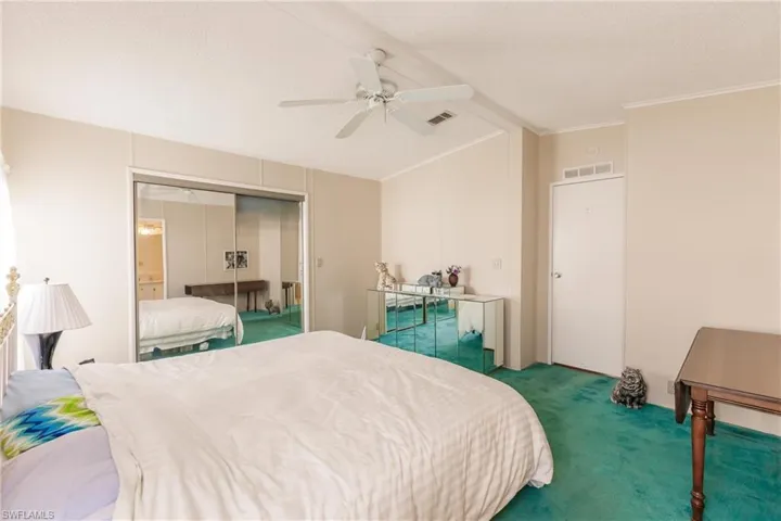 Bedroom with carpet floors, a closet, crown molding, a textured ceiling, and ceiling fan
