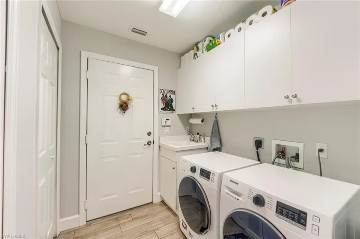 Easy access to the garage, large sink and extra storage cabinets
