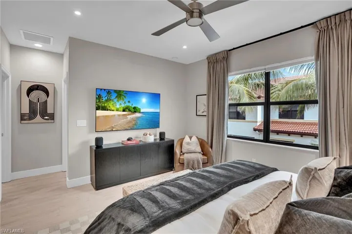 Bedroom with wood finished floors, recessed lighting, and ceiling fan