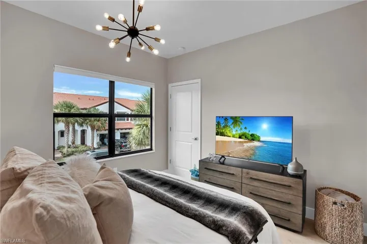 Bedroom featuring a chandelier and light wood-style floors