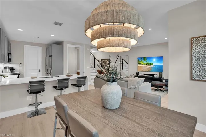 Dining room with stairs, recessed lighting, and light wood-type flooring
