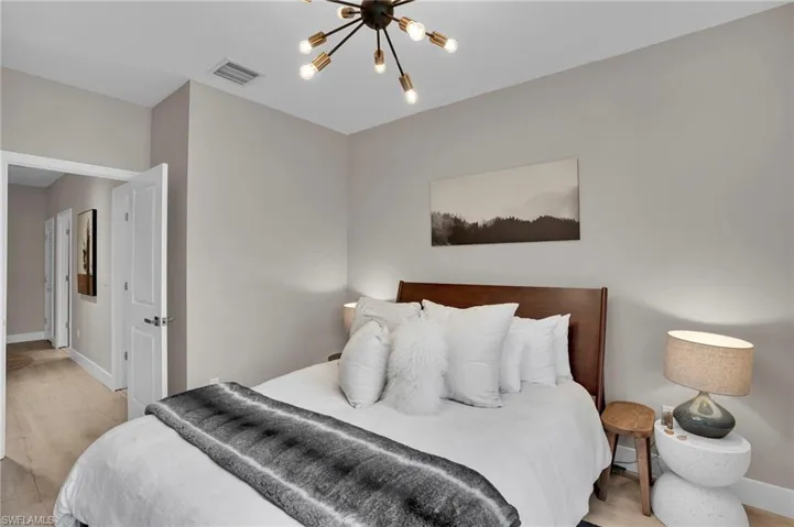 Bedroom featuring light wood-style floors and a chandelier