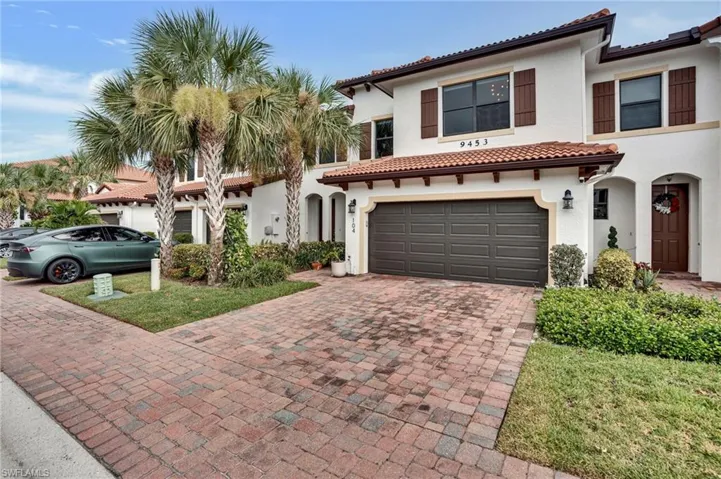 Mediterranean / spanish-style home featuring stucco siding, decorative driveway, a garage, and a tile roof