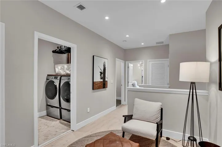 Sitting room featuring separate washer and dryer, recessed lighting, and wood finished floors