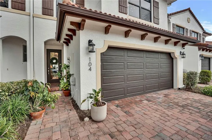 Garage featuring decorative driveway