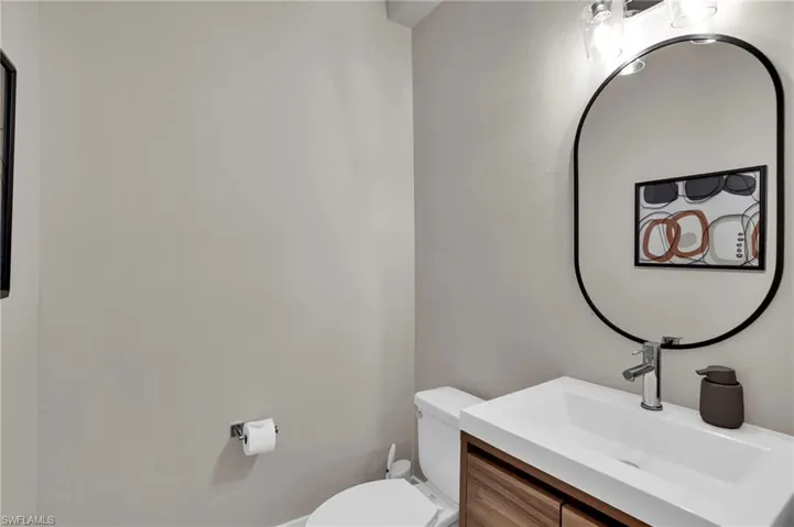 Half bathroom featuring toilet and vanity
