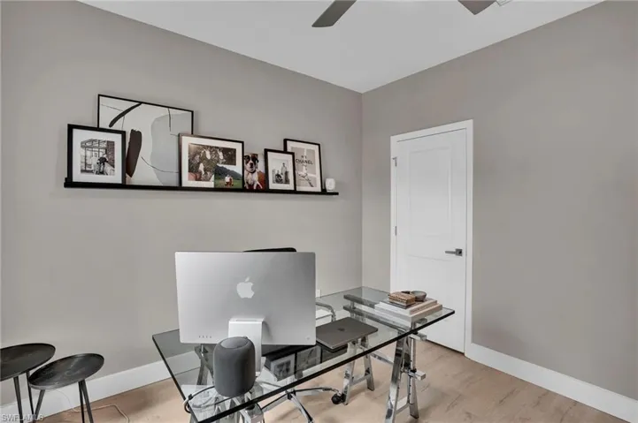 Office area featuring wood finished floors and ceiling fan