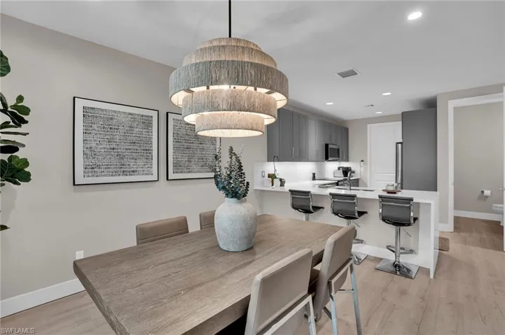 Dining space featuring light wood-type flooring and recessed lighting