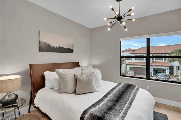 Bedroom featuring a chandelier and wood finished floors