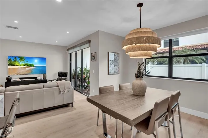 Dining room featuring light wood-type flooring and recessed lighting