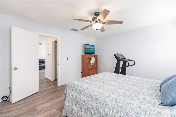 Bedroom featuring ceiling fan and hardwood / wood-style flooring