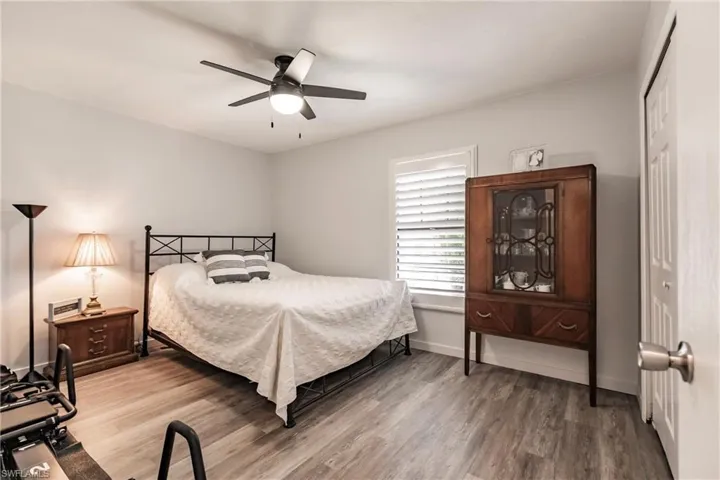 Bedroom with hardwood / wood-style flooring, a closet, and ceiling fan