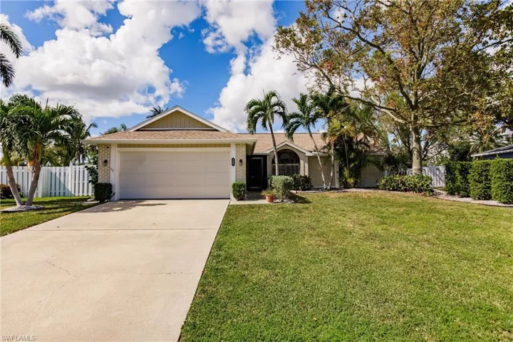 Single story home with a front yard and a garage