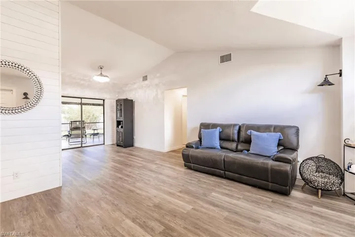 Living room featuring light hardwood / wood-style floors and vaulted ceiling