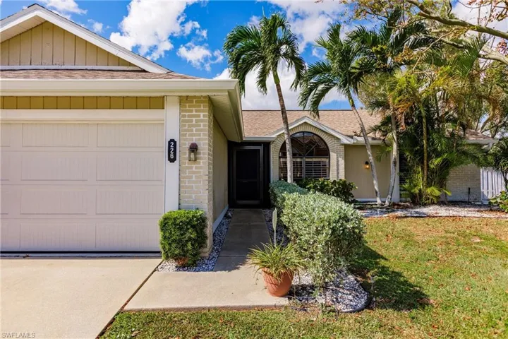 Ranch-style house with a front lawn and a garage
