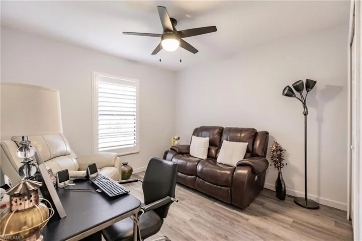 Living room featuring ceiling fan and light hardwood / wood-style flooring
