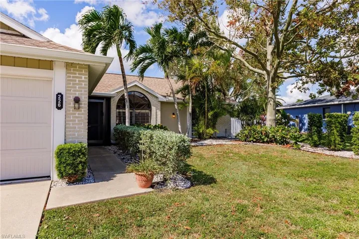 Ranch-style home with a front lawn and a garage
