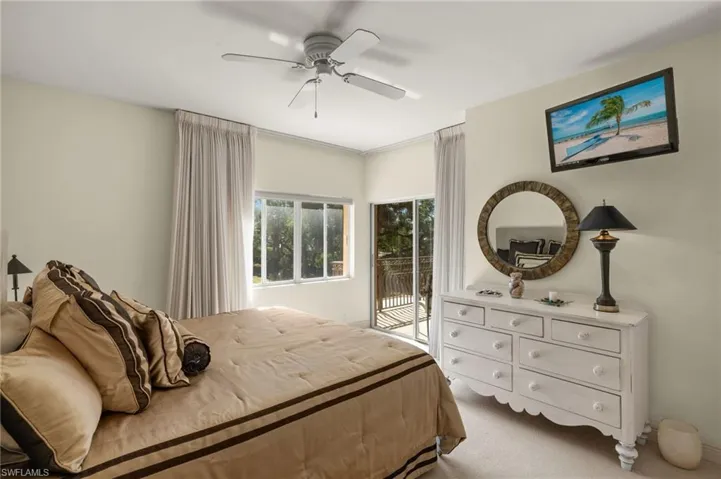 Guest bedroom featuring access to exterior and ceiling fan