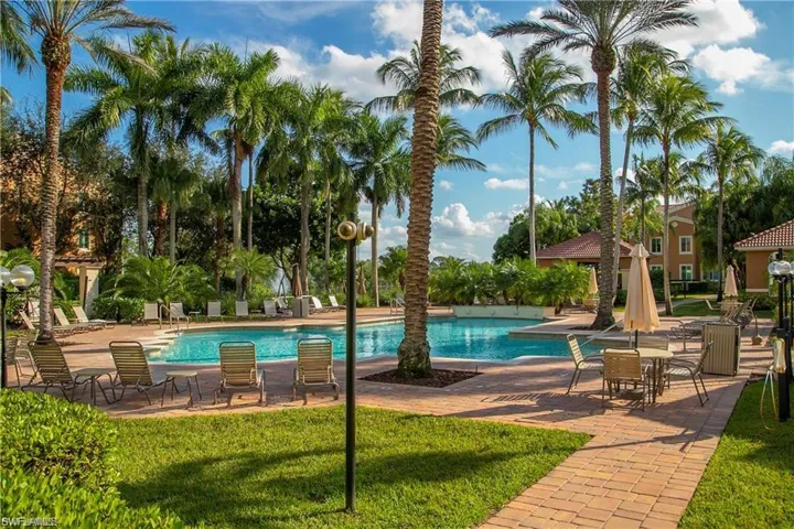 Community pool with a patio area and a lawn