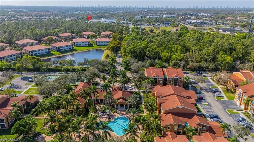 Aerial view of property and surrounding area with a large body of water and nearby suburban area