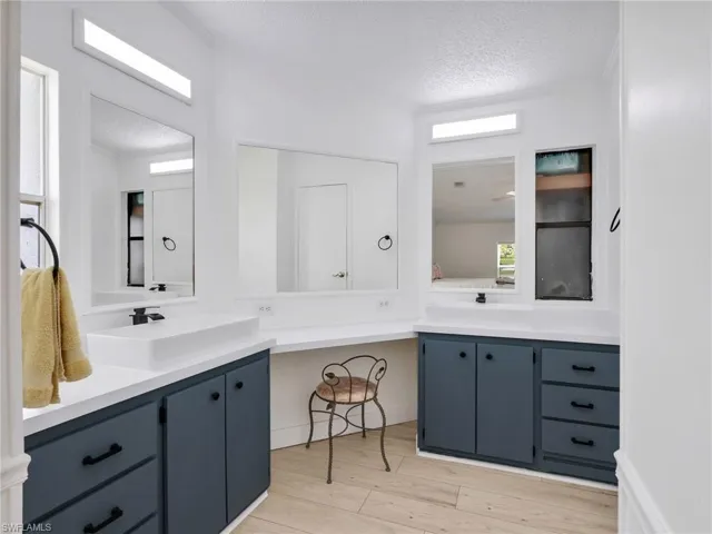 Bathroom featuring wood-finish flooring, white walls, and a white ceiling