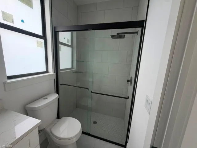 Shower enclosure with clear glass doors and matte black framing