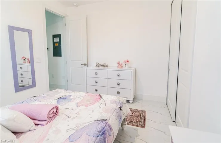 Room featuring white walls and white tile flooring