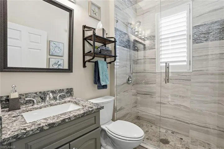 Full bathroom featuring a shower stall and vanity